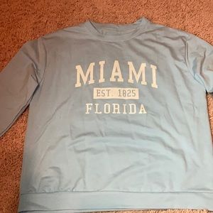 A blue and white MIAMI sweatshirt